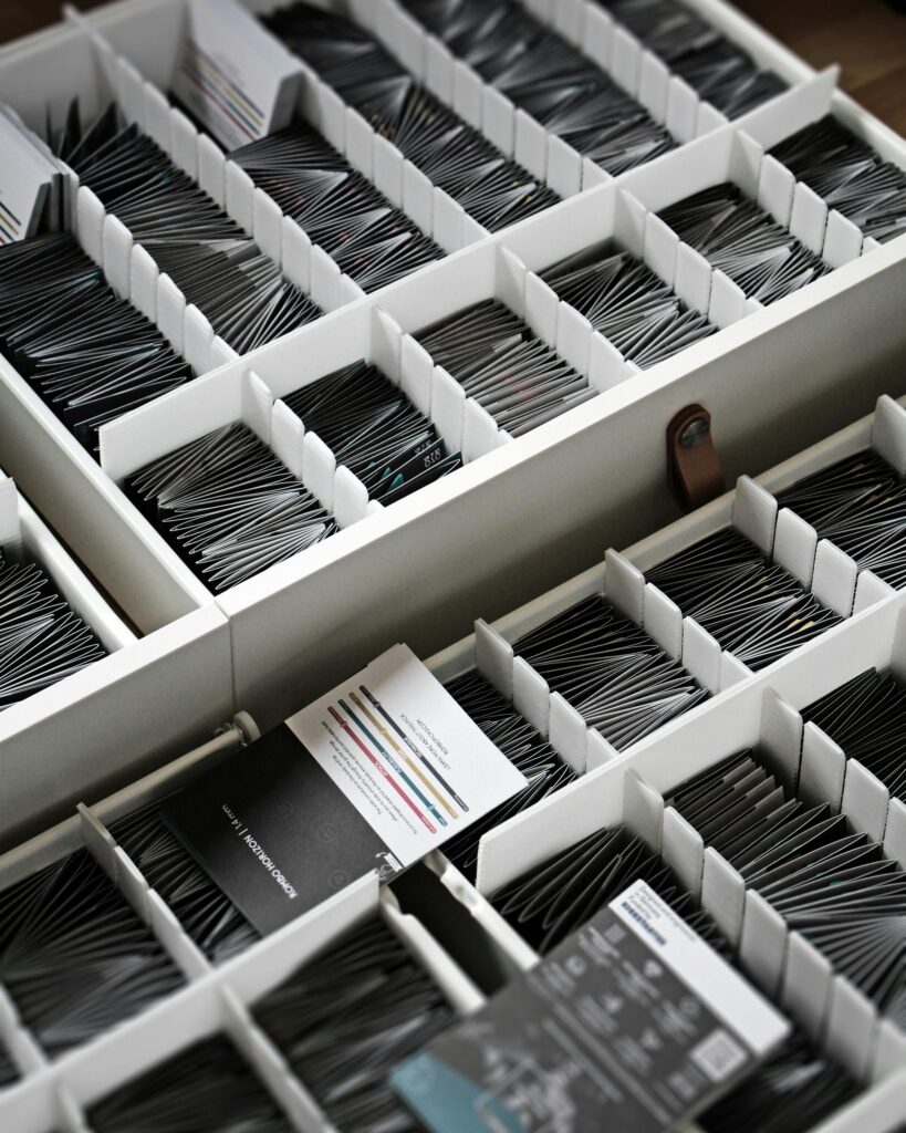 Top view of a drawer filled with neatly organized card holders showcasing minimalism.